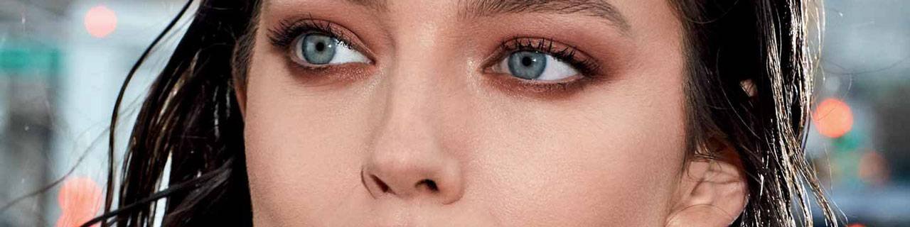 Face Makeup Tutorials illustrative banner image - close up on woman's Eyes, city background