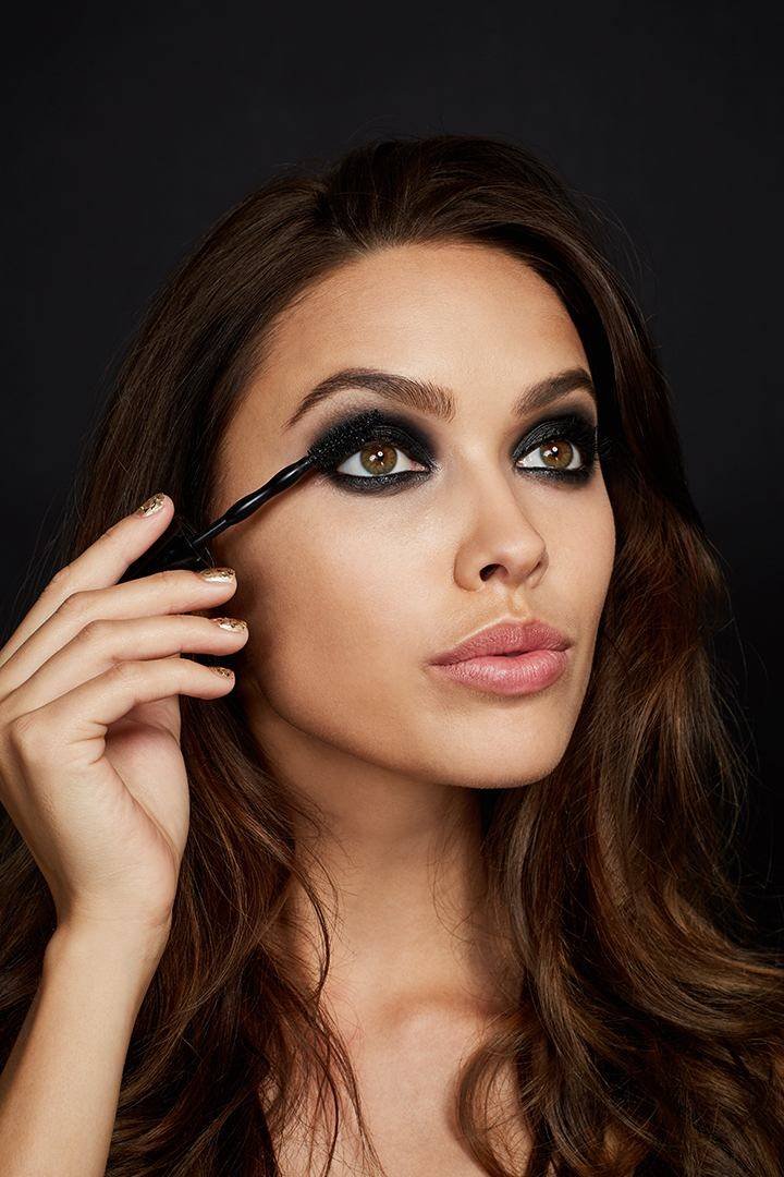 Mulher a utilizar uma maquilhagem com olhos destacados a preto