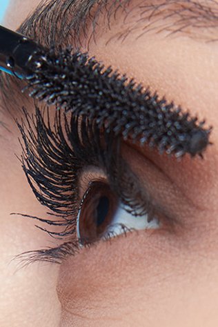 Close up of a woman applying mascara on her Eyelashes